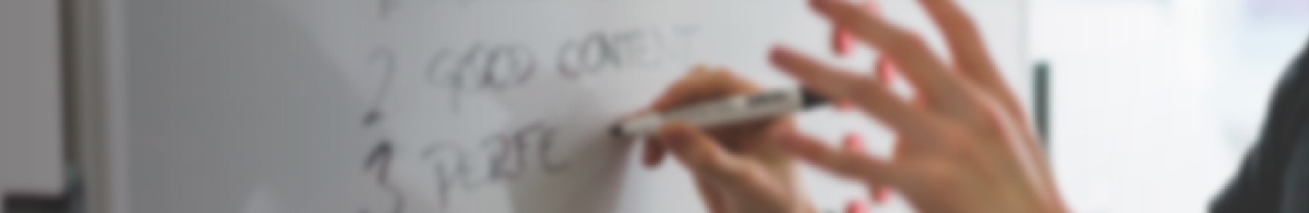 person writing on a white board